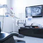 Dentists,Chair,And,Tools,With,X-ray,Picture,On,Tv,In