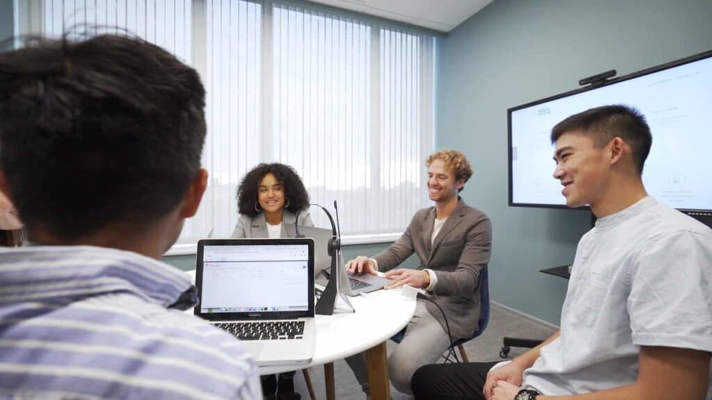 Diverse professionals engaged in a collaborative IT solutions meeting at CNiC Solutions office.