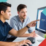 Innovative IT support team working on Microsoft Office 365 on desktop computer at CNiC Solutions.