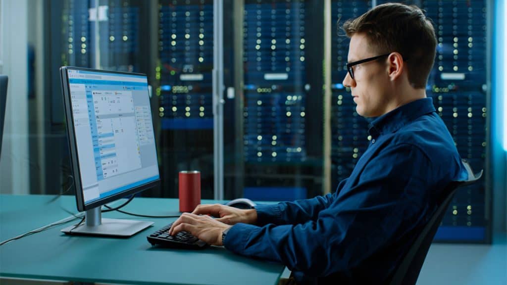 Efficient IT professional working on network management at CNiC Solutions data center.