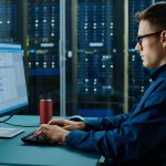 Efficient IT professional working on network management at CNiC Solutions data center.