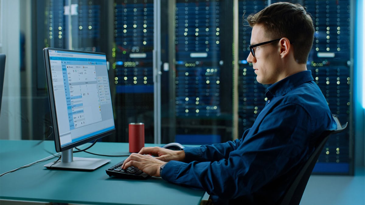 Efficient IT professional working on network management at CNiC Solutions data center.