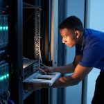 Expert IT technician configuring server hardware in a data center for optimal performance and security.