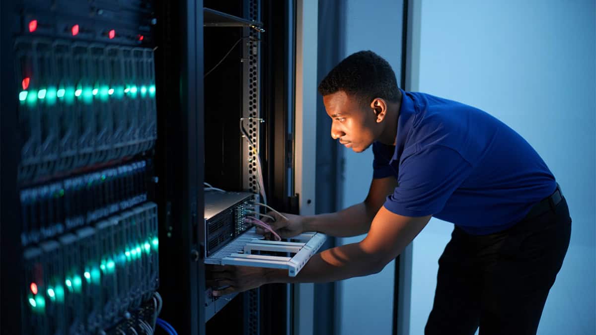 Expert IT technician configuring server hardware in a data center for optimal performance and security.