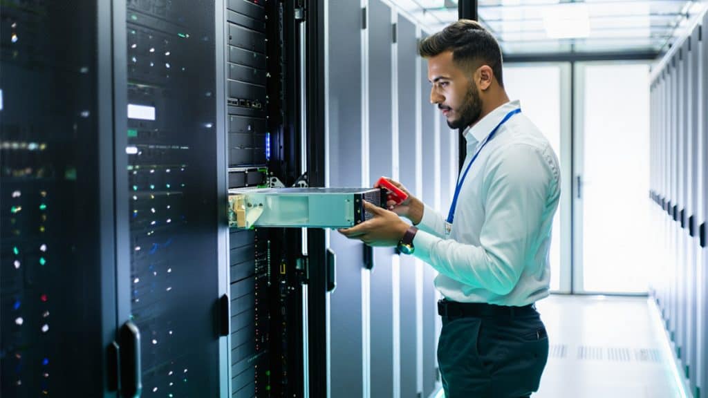 High-tech IT professional servicing server racks in a data center, showcasing reliable IT support and managed IT services by CNiC Solutions.