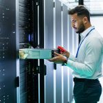 High-tech IT professional servicing server racks in a data center, showcasing reliable IT support and managed IT services by CNiC Solutions.