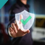 Business professional touching a digital shield with a checkmark, symbolizing cybersecurity and data protection services.