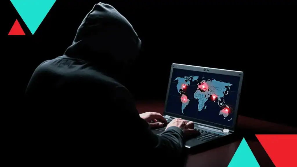 Cybersecurity threat hacker analyzing global data breach map on laptop in dark setting.
