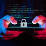 Hacker with hands holding a smartphone with a lock icon, symbolizing cybersecurity and data protection services by CNiC Solutions.