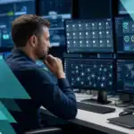 IT professional monitoring network security and infrastructure with multiple screens in a managed IT environment.