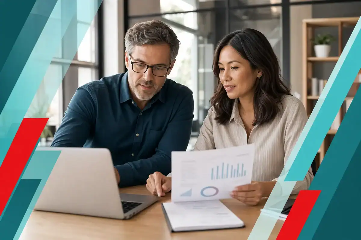 Business owner reviewing an IT cost comparison with a technology advisor
