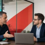 IT consulting and cybersecurity discussion between professionals in a modern office setting.