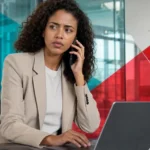 Businesswoman using a laptop for IT solutions and cybersecurity services in Houston, TX.