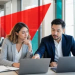 Two business colleagues comparing Google Workspace and Microsoft 365 options on laptops in a modern office