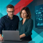 IT professionals analyzing cybersecurity data on a laptop in a modern office setting.