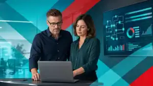 IT professionals analyzing cybersecurity data on a laptop in a modern office setting.