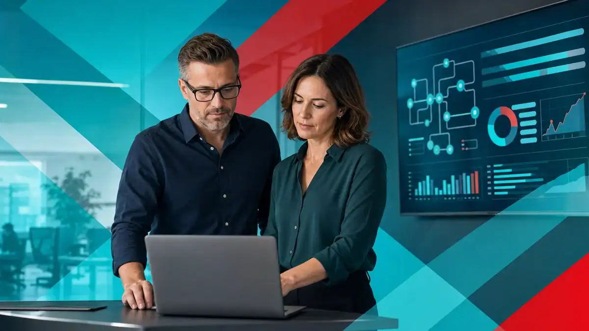 IT professionals analyzing cybersecurity data on a laptop in a modern office setting.