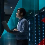 IT professional analyzing network data on a large digital screen in a data center.