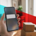 Hand holding a smartphone showing a text notification with delivery parcels blurred in the background