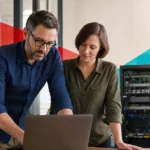 IT professionals collaborating on network infrastructure and cybersecurity solutions in a modern office.