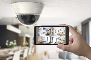 High-tech security camera monitoring a modern living room with a smartphone control system.